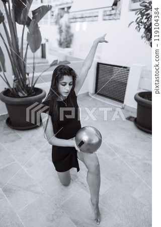 An Elegant Bowling Enthusiast Posing Gracefully in a Stylish Black Dress Indoors An Elegant Bowling Enthusiast Posing Gracefully in a Stylish Black Dress Indoors 119104384