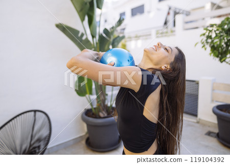 A Fitness Enthusiast Who is Embracing an Energetic and Engaging Workout with a Stability Ball A Fitness Enthusiast Who is Embracing an Energetic and Engaging Workout with a Stability Ball 119104392