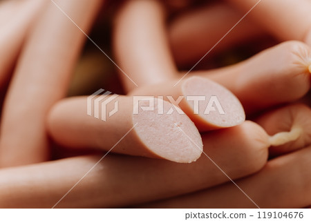 Stack of sausages on plate, ideal for BBQ, grilling, or quick meals, displayed in a kitchen setting 119104676