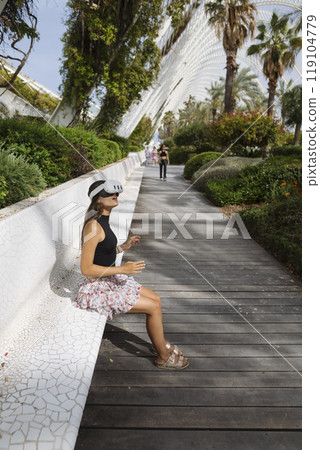 Enjoying a Casual Stroll in a Beautiful and Lush Urban Garden Setting on a Bright Day 119104779