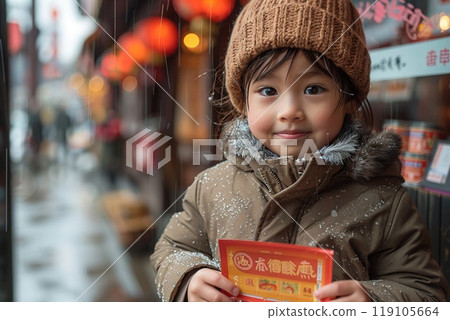 A child receiving a red envelope during Lunar New Year celebrations 119105664