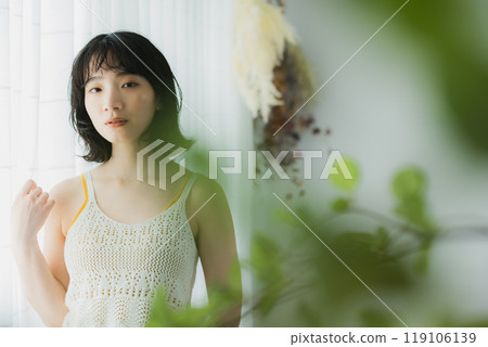 Woman opening curtain 119106139