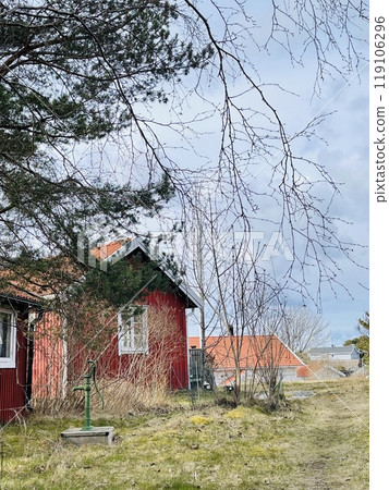 A view of red wooden houses on Donso Archipelago island . A view of red wooden houses on Donso Archipelago island . 119106296