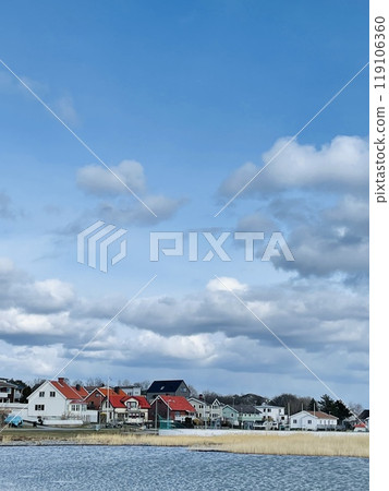 A view of red wooden houses on Donso Archipelago island . 119106360