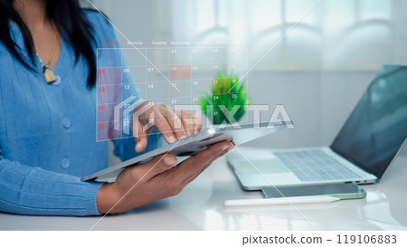 Businesswoman marking dates on virtual calendar with tablet, Managing his business schedule, Setting reminders for important appointments, creative collage for planning ideas, Appointment scheduler. 119106883