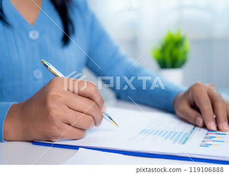 Businesswoman show paper documents to analyze business and manage corporate data, Business analytics with charts KPIs to improve organizational performance, Marketing and financial strategy. Businesswoman show paper documents to analyze business and manage corporate data, Business analytics with charts KPIs to improve organizational performance, Marketing and financial strategy. 119106888