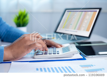Businesswoman hand working with finances about cost and calculator and laptop with tablet on desk at office in morning light, Business accounting concept, Calculating or checking balance. Businesswoman hand working with finances about cost and calculator and laptop with tablet on desk at office in morning light, Business accounting concept, Calculating or checking balance. 119106889