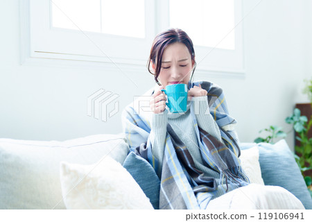 Unwell woman resting in the living room Unwell woman resting in the living room 119106941