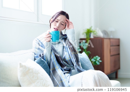 Unwell woman resting in the living room Unwell woman resting in the living room 119106945