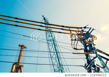 Electric wire protection covers around the construction site and cranes stretching into the blue sky b-4 Warm colors Electric wire protection covers around the construction site and cranes stretching into the blue sky b-4 Warm colors 119108213