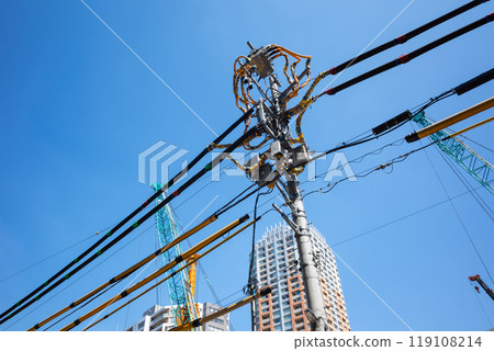 Electric wire protection covers around the construction site and cranes stretching into the blue sky c-1 Electric wire protection covers around the construction site and cranes stretching into the blue sky c-1 119108214