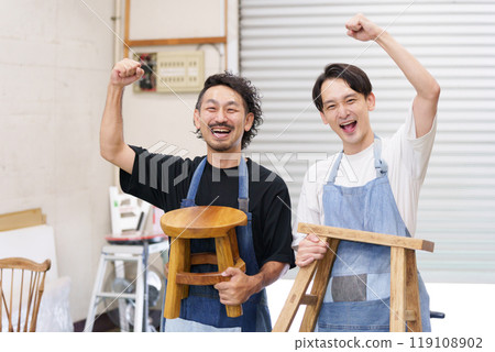 Men making DIY chairs (fist pump) 119108902