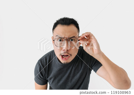 Serious angry face freelance man bun hair in black on white. 119108963