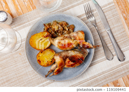 Delicious roasted quails in plate with fried potato 119109441
