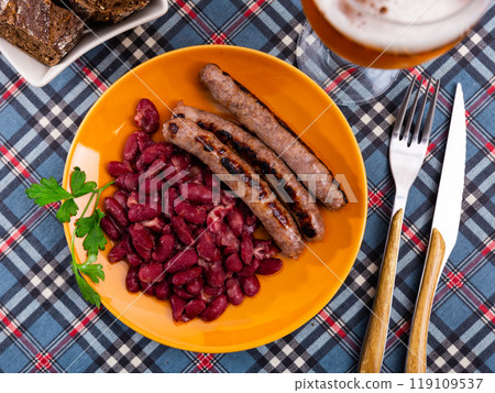 Fried botifarra sausage served with stewed red beans Fried botifarra sausage served with stewed red beans 119109537