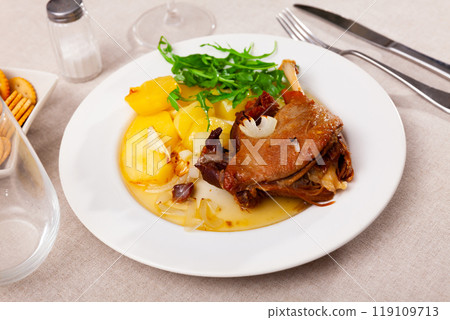 French dish duck confit with arugula on table 119109713