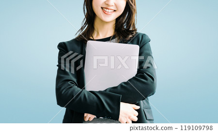 Smiling Japanese business woman with a laptop Smiling Japanese business woman with a laptop 119109798