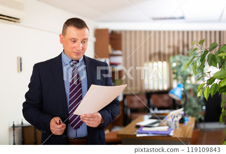 Portrait of concentrated man working at office Portrait of concentrated man working at office 119109843