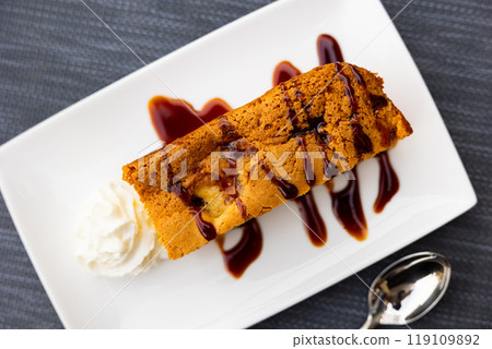 Piece of apple pie with chocolate sauce and cream Piece of apple pie with chocolate sauce and cream 119109892
