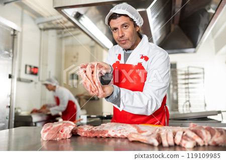 Butcher offering fresh raw lamb ribs for sale 119109985