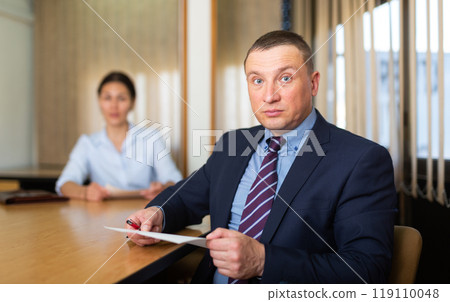Woman boss firing upset adult male employee Woman boss firing upset adult male employee 119110048