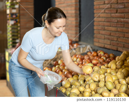 Female customer made beeline for fresh produce section, pick potato and puts it in bag Female customer made beeline for fresh produce section, pick potato and puts it in bag 119110130