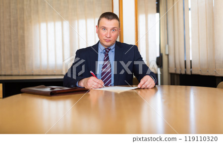 Portrait of concentrated man working at office Portrait of concentrated man working at office 119110320