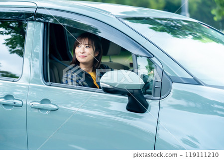 Woman in a car, woman going for a drive 119111210
