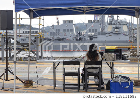 DJ standing at the naval port 119111682