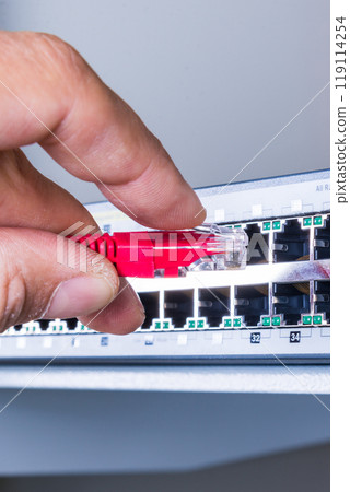 hand with red ethernet cable hand with red ethernet cable 119114254