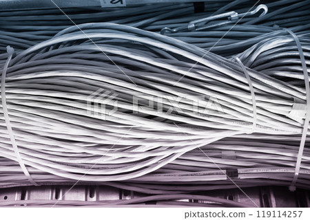 bunch of network cables in wave pattern leading across server ro 119114257