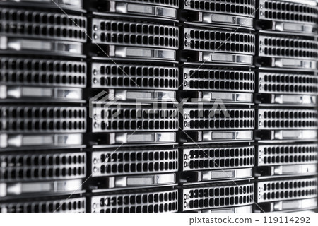 Cluster of data storage hard drives inside server room 119114292