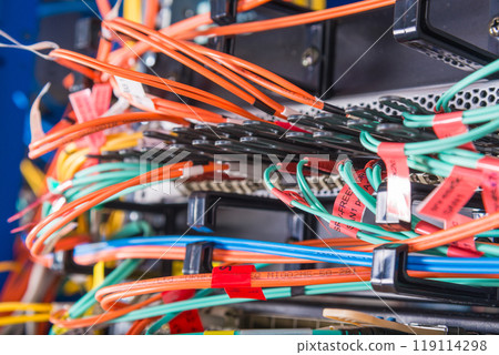 hand of engineer plugging in ethernet cable into server switch p 119114298