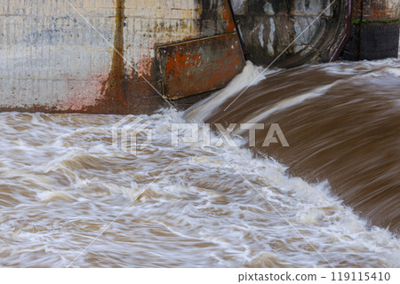 Heavy rains have turned a normally tranquil mountain stream into a dangerously swollen torrent. Heavy rains have turned a normally tranquil mountain stream into a dangerously swollen torrent. 119115410