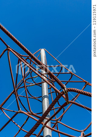 Rope jungle gym, vertical position, against a clear, blue sky without a single cloud 119115971