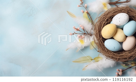 wicker basket with Easter eggs in pastel colors on a blue concrete background, Easter background 119116192