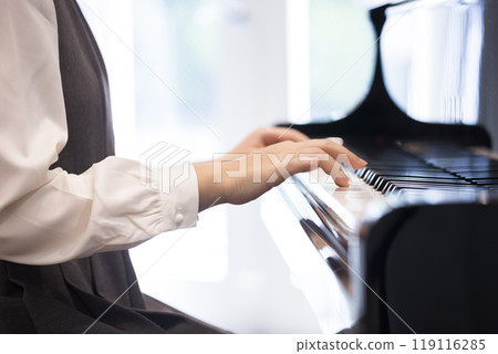 Junior high school girl playing piano 119116285