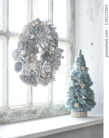 Christmas wreath and Christmas tree on the window sill 119117003