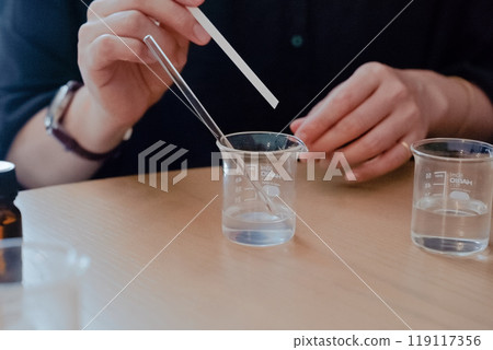 A woman mixing essential oils to make perfume 03 A woman mixing essential oils to make perfume 03 119117356