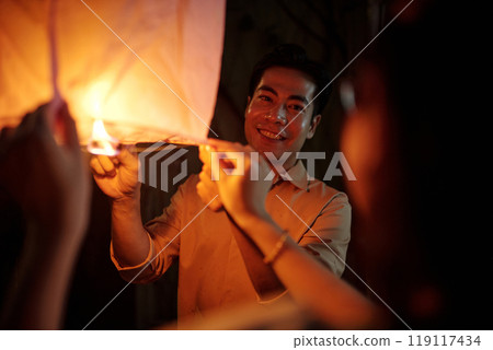 Happy Couple Celebrating Holiday With Lantern 119117434