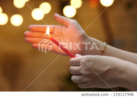 Woman Lightning The Candle For Holiday 119117496
