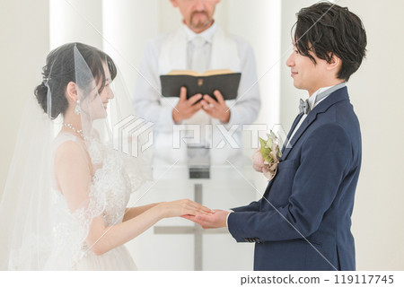 Bride and groom having a wedding ceremony in a church or chapel (wedding/bridal) Bride and groom having a wedding ceremony in a church or chapel (wedding/bridal) 119117745
