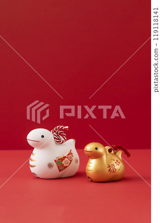 New Year's material. The zodiac sign of the snake. A snake figurine on a red background New Year's material. The zodiac sign of the snake. A snake figurine on a red background 119118141