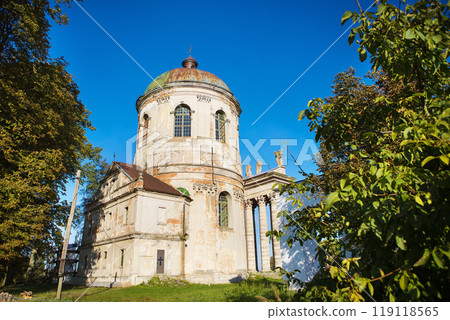 Old church of Exaltation 18th century near Pidhirtsi Castle between trees, Ukraine 119118565