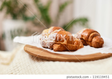 Delicious fresh french croissants on wooden tray for breakfast in bed in the morning, tasty breakfast Delicious fresh french croissants on wooden tray for breakfast in bed in the morning, tasty breakfast 119119451