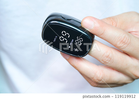 A device to measure the oxygen saturation of a person at the fingertips. And checking oxygen depletion is an emergency sign of pneumonia caused by the COVID-19 virus. A device to measure the oxygen saturation of a person at the fingertips. And checking oxygen depletion is an emergency sign of pneumonia caused by the COVID-19 virus. 119119912