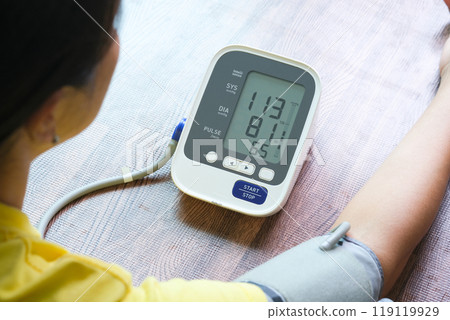 Man check blood pressure monitor and heart rate monitor with digital pressure gauge. Health care and Medical concept 119119929