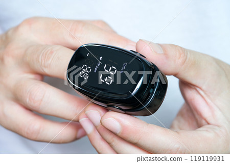 A device to measure the oxygen saturation of a person at the fingertips. And checking oxygen depletion is an emergency sign of pneumonia caused by the COVID-19 virus. A device to measure the oxygen saturation of a person at the fingertips. And checking oxygen depletion is an emergency sign of pneumonia caused by the COVID-19 virus. 119119931