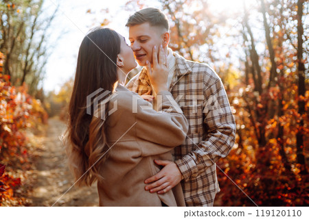 Couple in love newlyweds in casual clothes travel together, hike and walk in autumn forest in nature Couple in love newlyweds in casual clothes travel together, hike and walk in autumn forest in nature 119120110