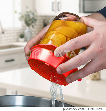 Small red plastic colander. Colander of modern plastic strainer in the kitchen background Small red plastic colander. Colander of modern plastic strainer in the kitchen background 119120293